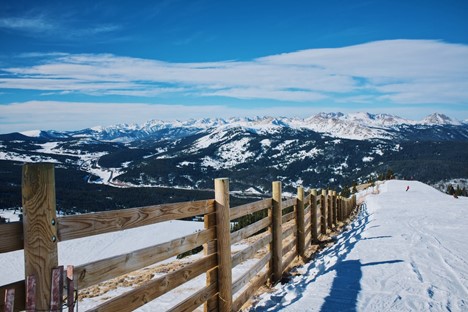 snowfield and brown wooden fence near mountain at daytime