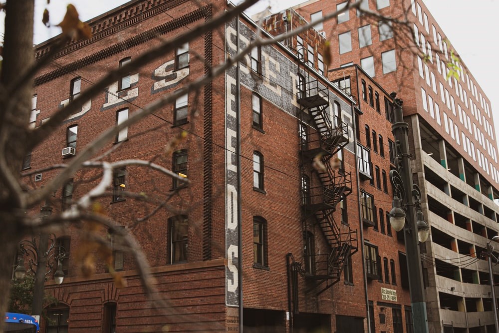 brown concrete building showing fire exit stair